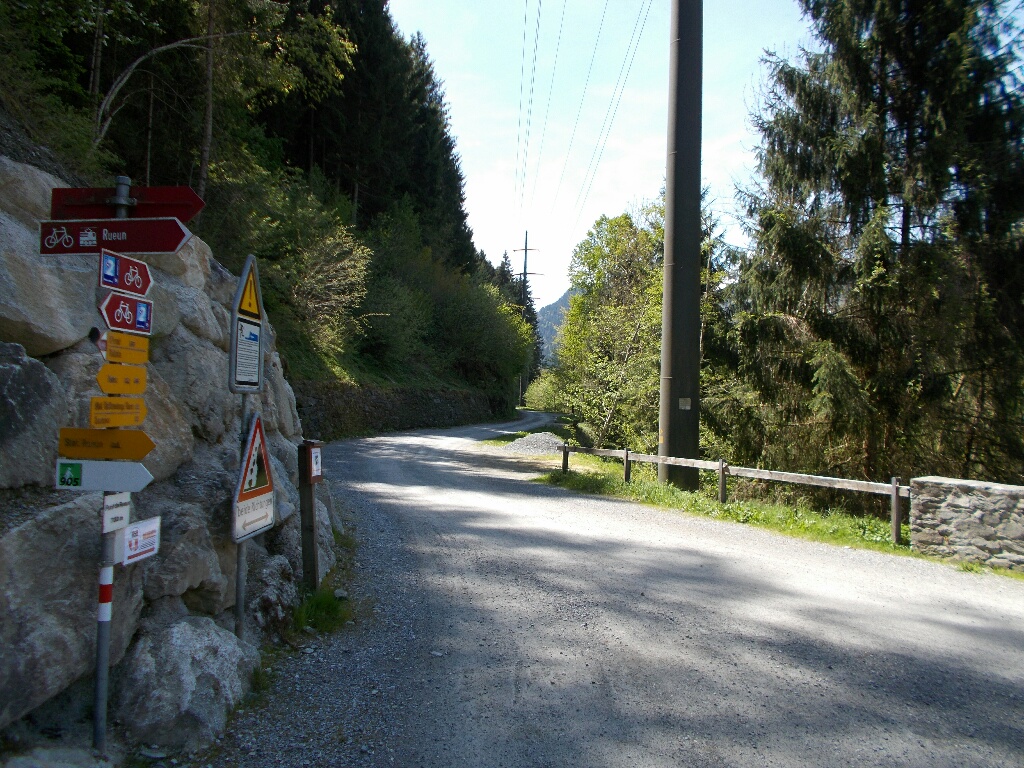Westward shot of the gravel pathway outside of Rueun, Switzerland. Signposting in the foreground.