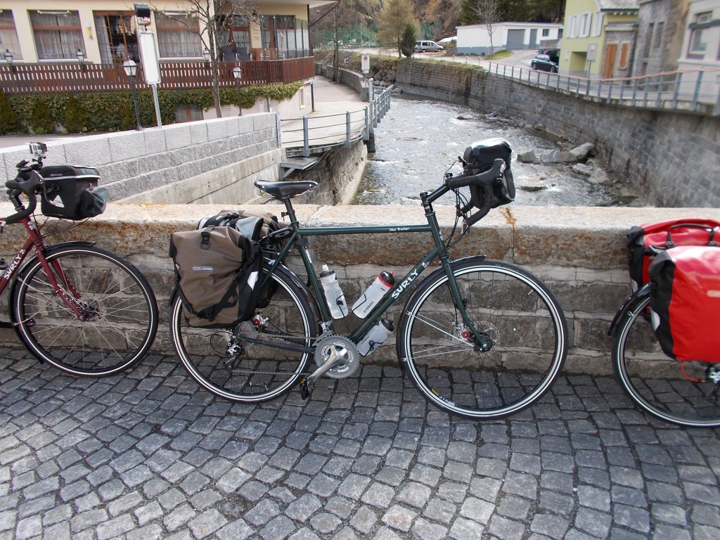 A 2013 Surly Disc Trucker leaning against a bridge in the town of Andermatt, Switzerland.