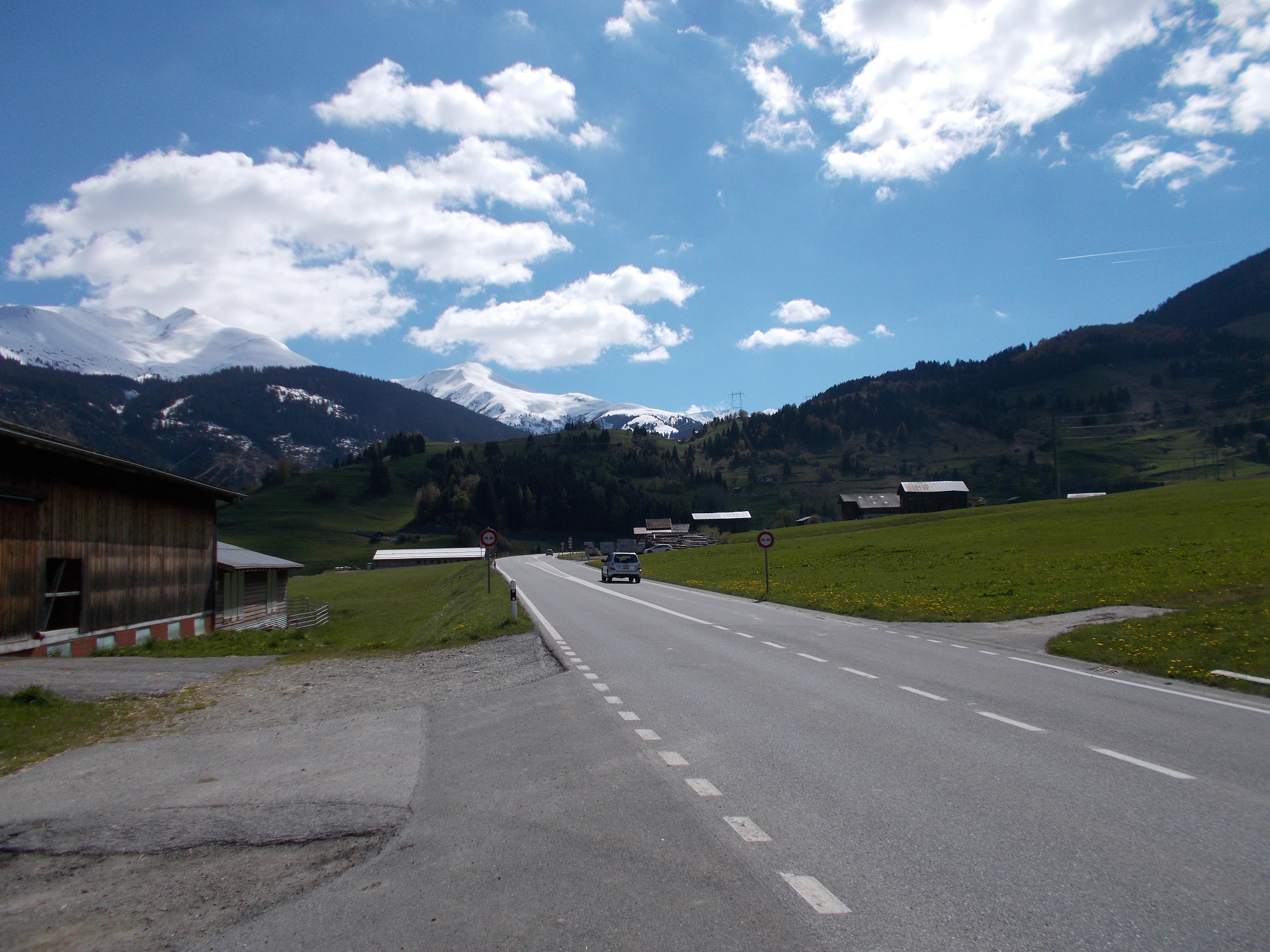 Scenic shot looking up a roadway in the Swiss mountains.