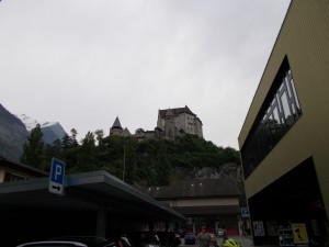 Picture of a large castle atop a hill, photographed from below.