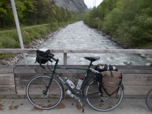 A green Surly Disc Trucker with loaded panniers.