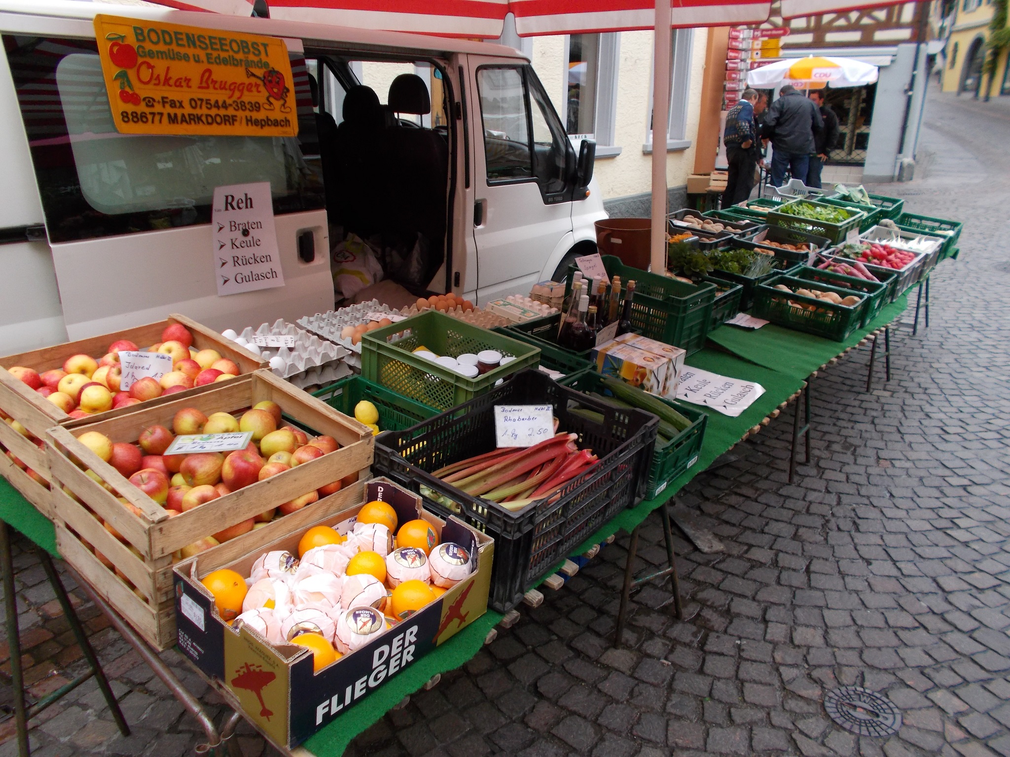 A van with a wide array of fruit, eggs, and vegetables laid out for market in Meersburg, Germany.